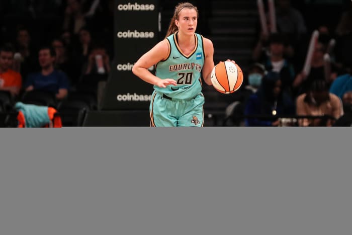 Sabrina Ionescu dribbles the ball.